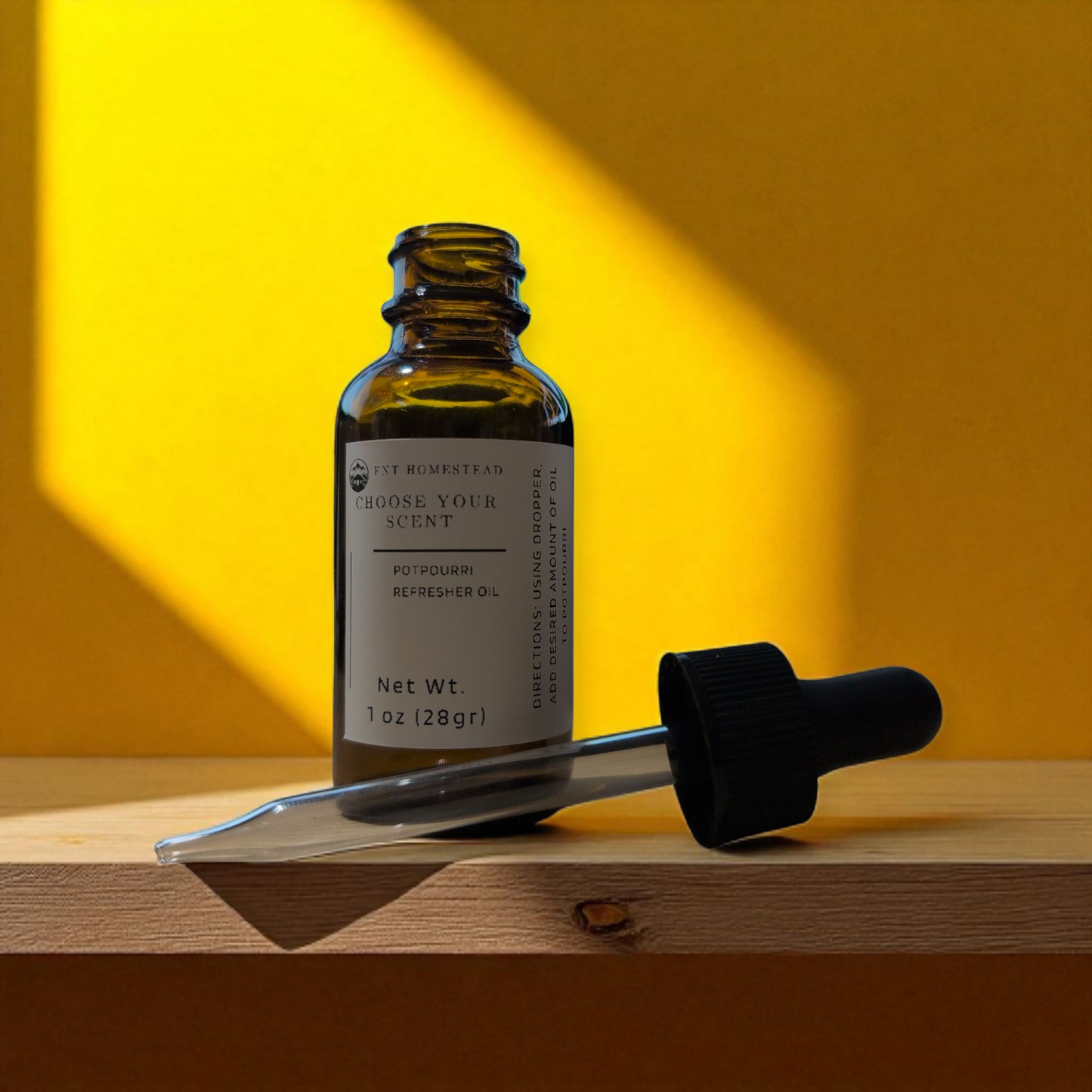 This is a bold and modern product photograph featuring high-contrast lighting.
An open, 1 oz. amber glass bottle of "Potpourri Refresher Oil" stands on a light-colored wooden shelf. Its black dropper top lies on its side in front of the bottle.
The background is a vibrant, sunny yellow wall. A sharp, diagonal shadow cuts across the scene from the top left, suggesting bright, direct sunlight from a window and creating a strong graphic quality. The overall mood is warm, cheerful, and contemporary.