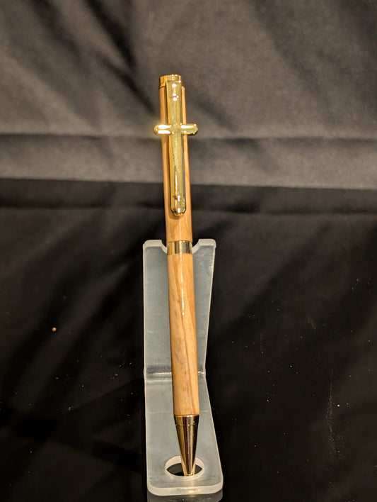 Gold pen on a clear stand against a black background