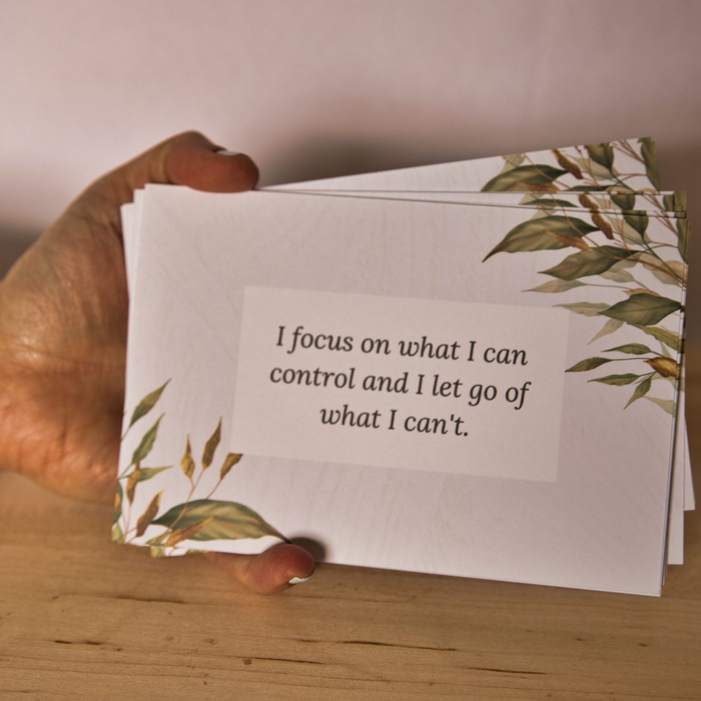 Affirmation cards held in hand to show size.